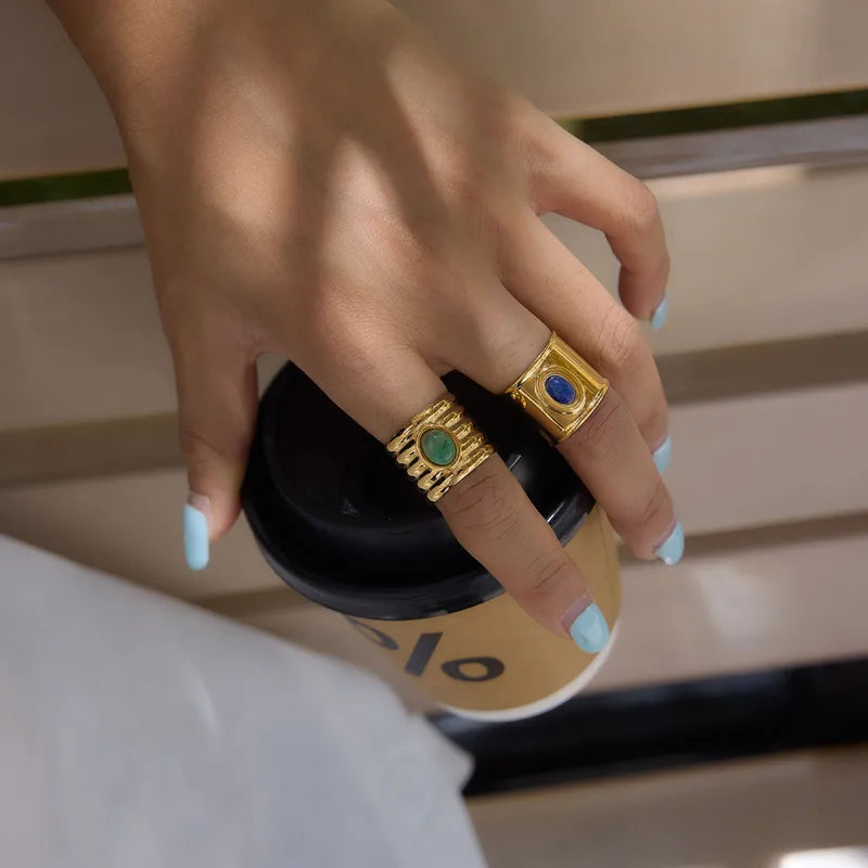 Naomi wide gold band ring with a blue oval stone, view 3