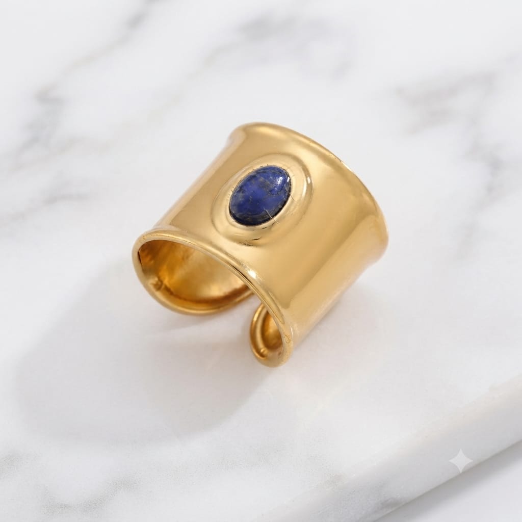 Naomi wide gold band ring with a blue oval stone
