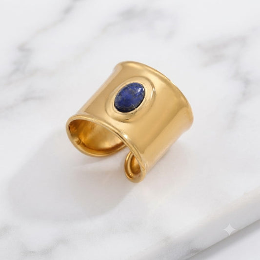 Naomi wide gold band ring with a blue oval stone