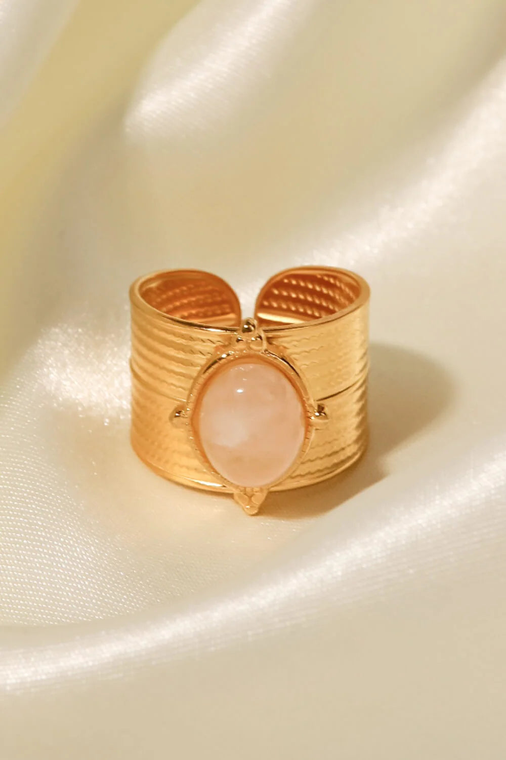 Daphne wide ribbed gold band ring with a pink oval stone, view 2