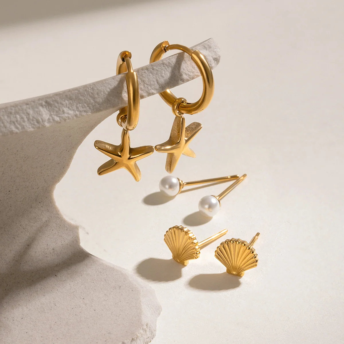 Melody gold earring set with starfish charm hoops, shell studs and pearl studs, view 4