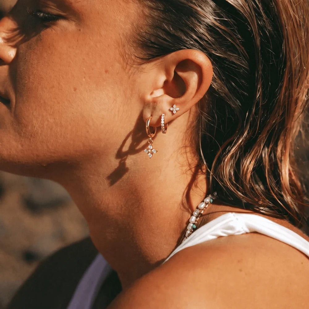 Eliza three piece gold earring set with crystal flower drop hoop, pave huggie and flower stud, view 3