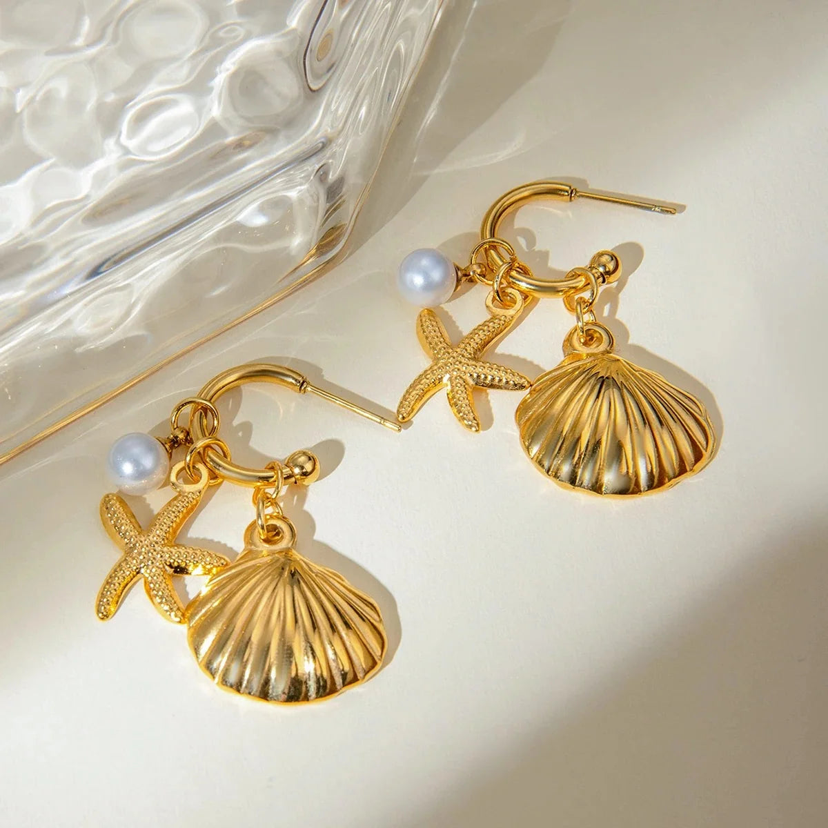 Marigold gold hoop earrings with shell, starfish and pearl charms, view 3