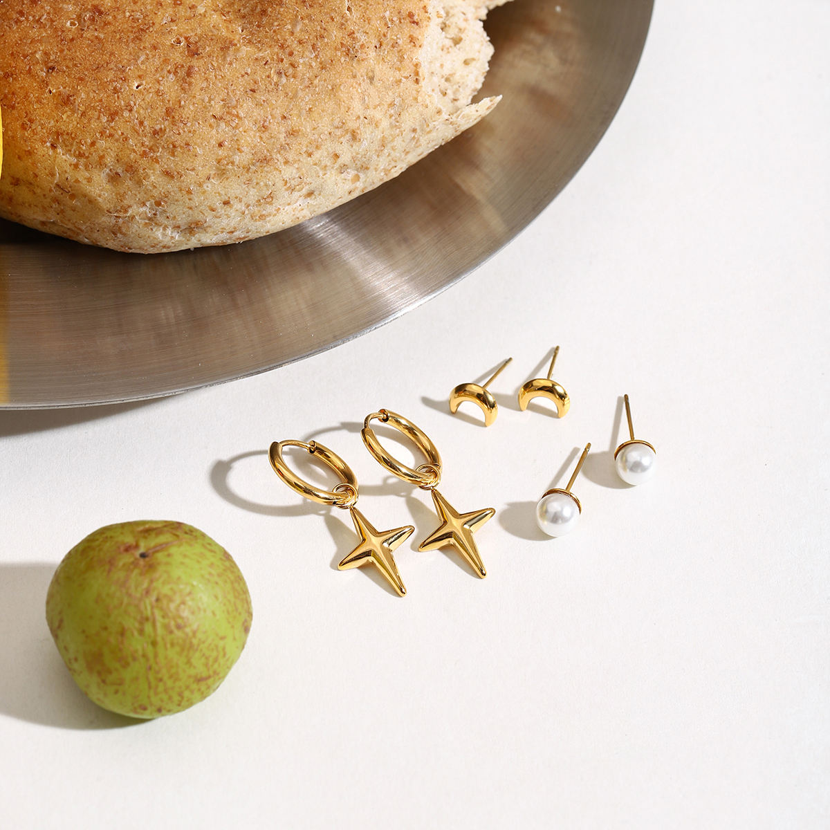 Maribel gold earring set with star charm hoops, pearl studs and moon studs, view 5