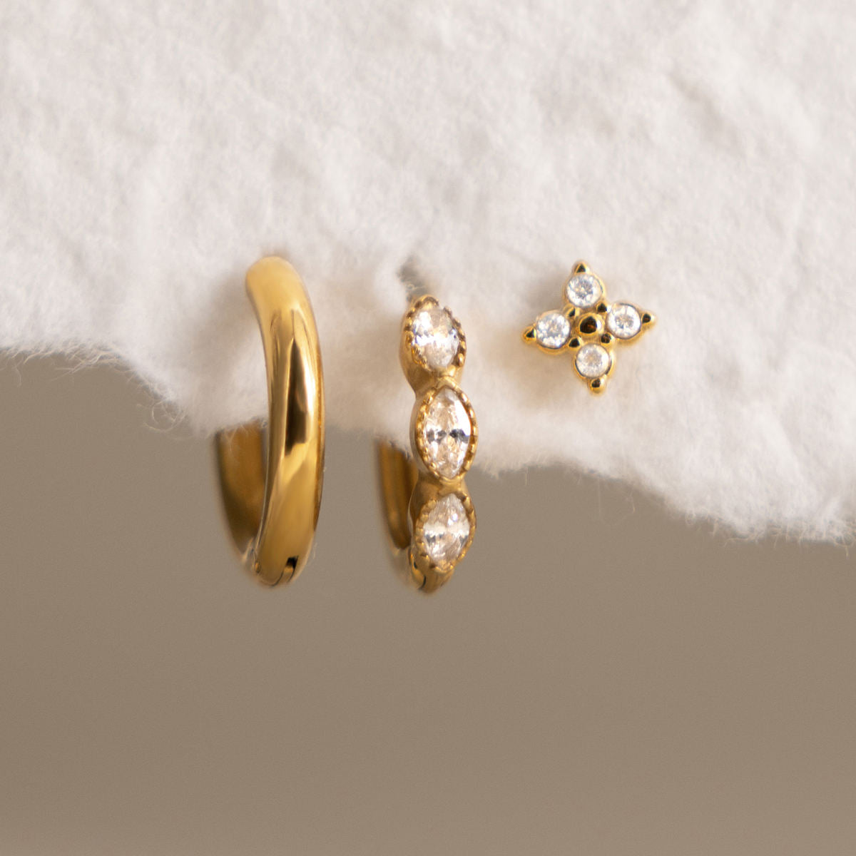 Cecily three piece gold earring set with plain hoop, clear marquise huggie and crystal flower stud, view 5