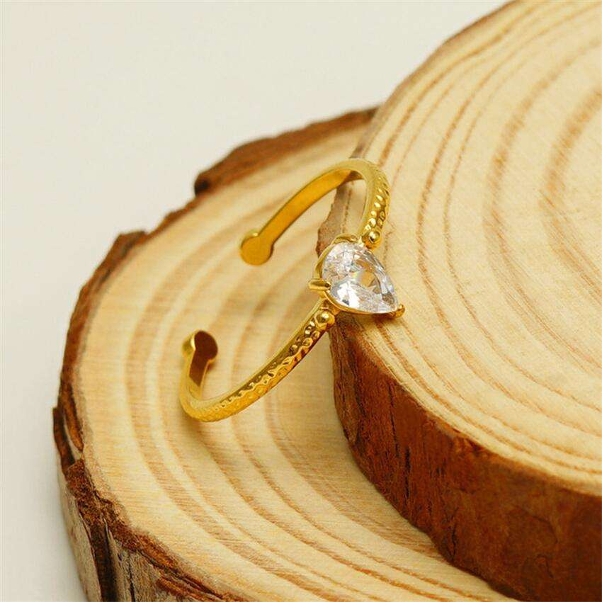 Natalie gold open ring with a pear cut solitaire stone