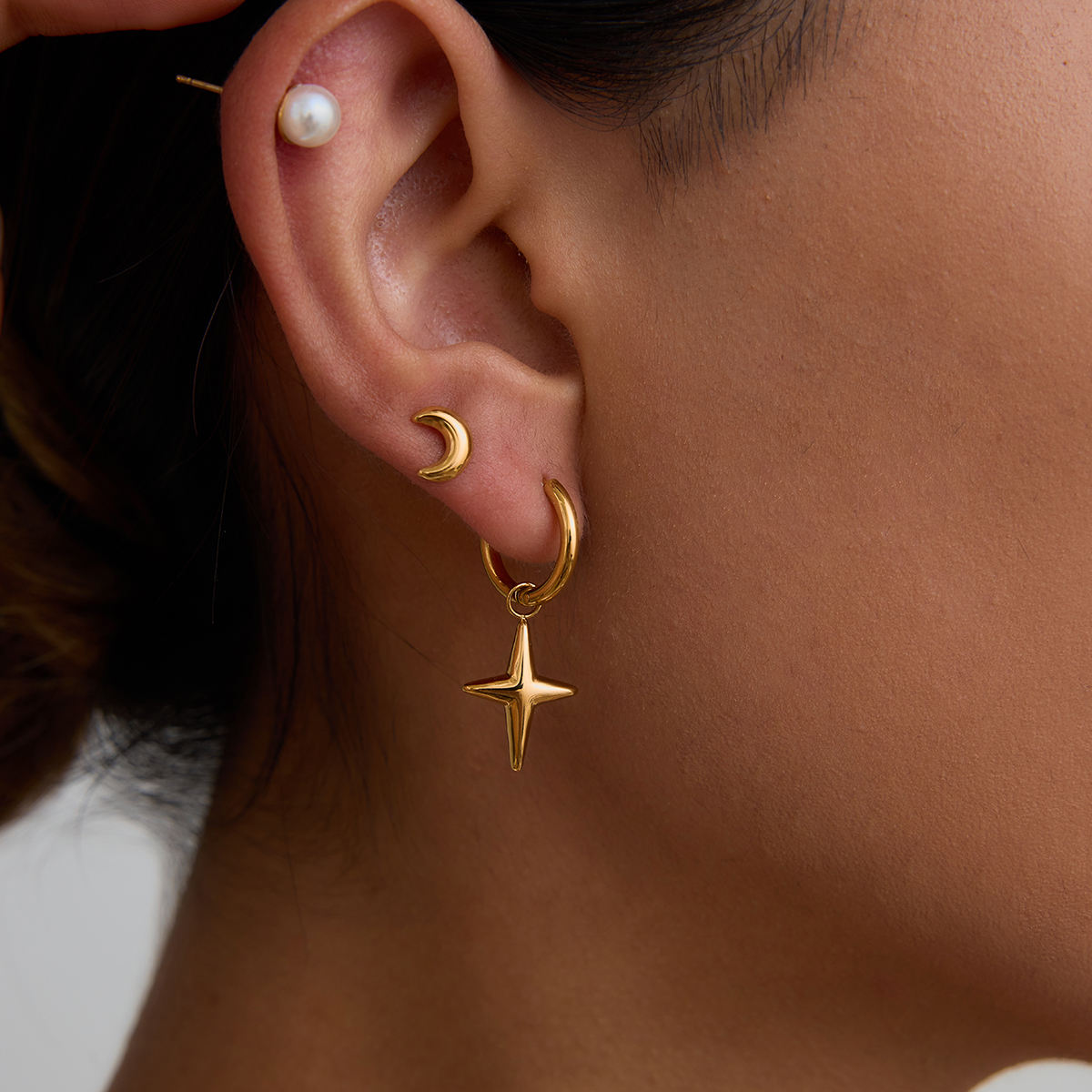 Maribel gold earring set with star charm hoops, pearl studs and moon studs, view 2