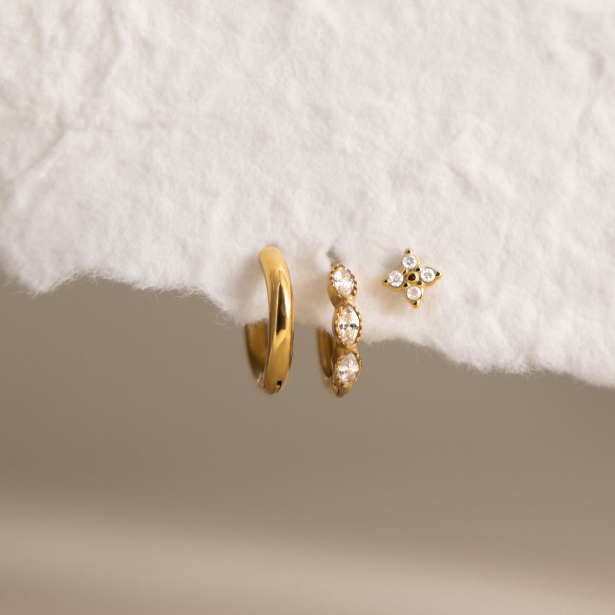 Cecily three piece gold earring set with plain hoop, clear marquise huggie and crystal flower stud, view 3