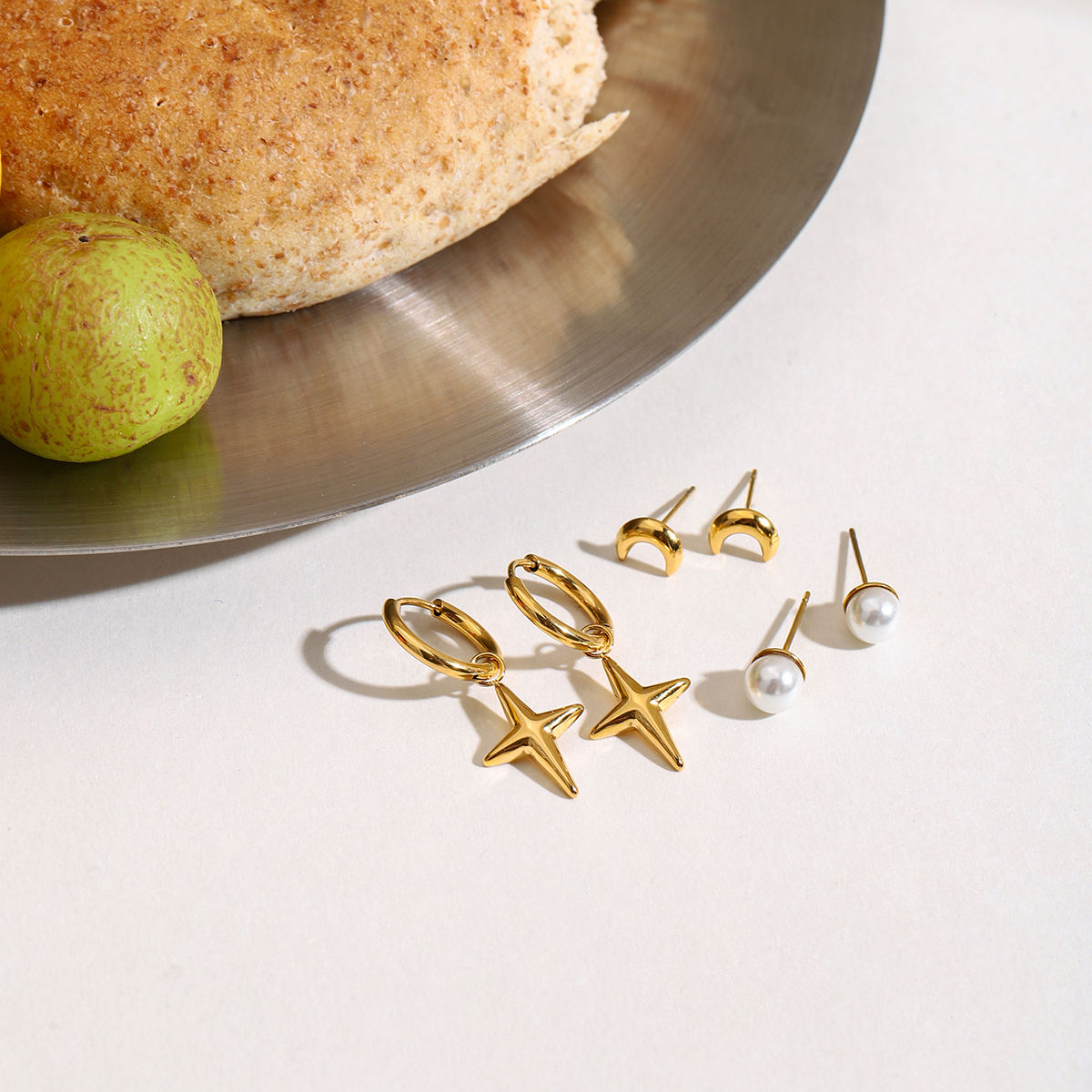 Maribel gold earring set with star charm hoops, pearl studs and moon studs, view 6