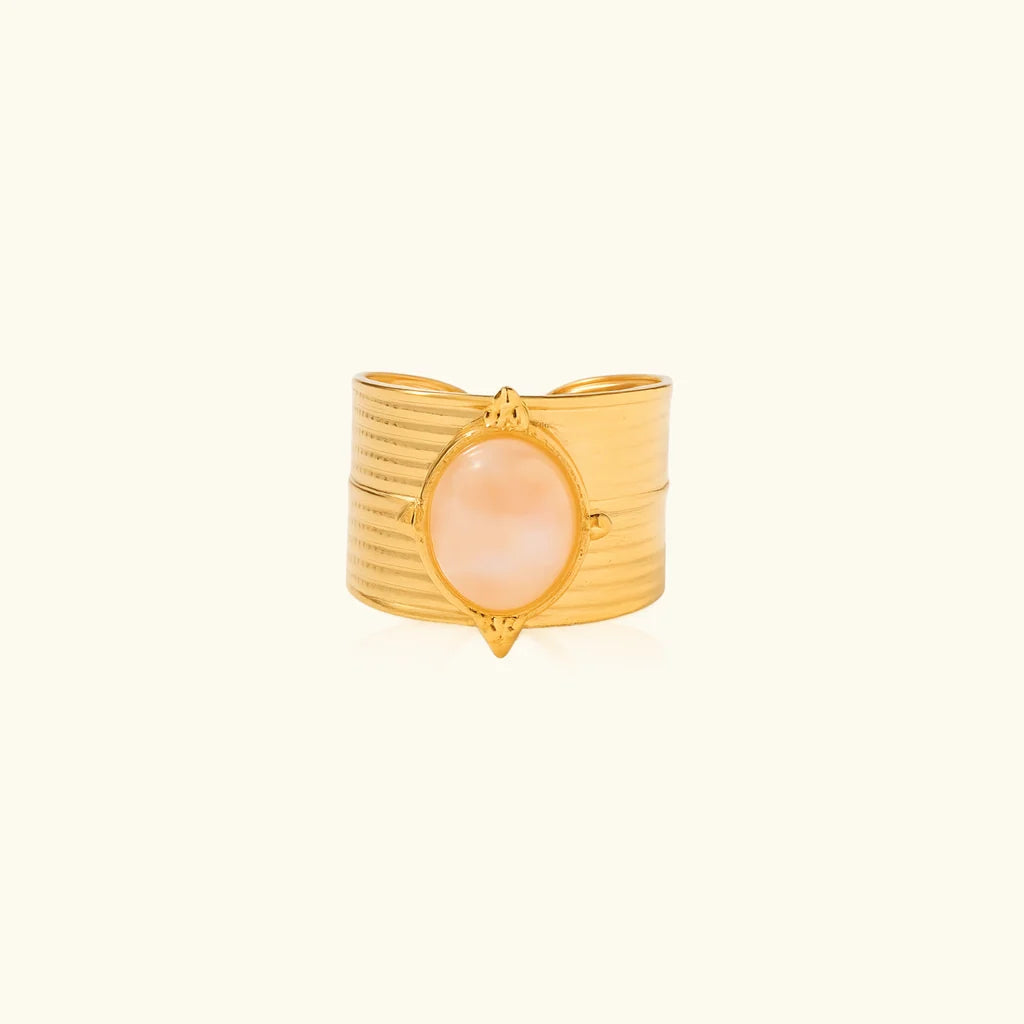 Daphne wide ribbed gold band ring with a pink oval stone