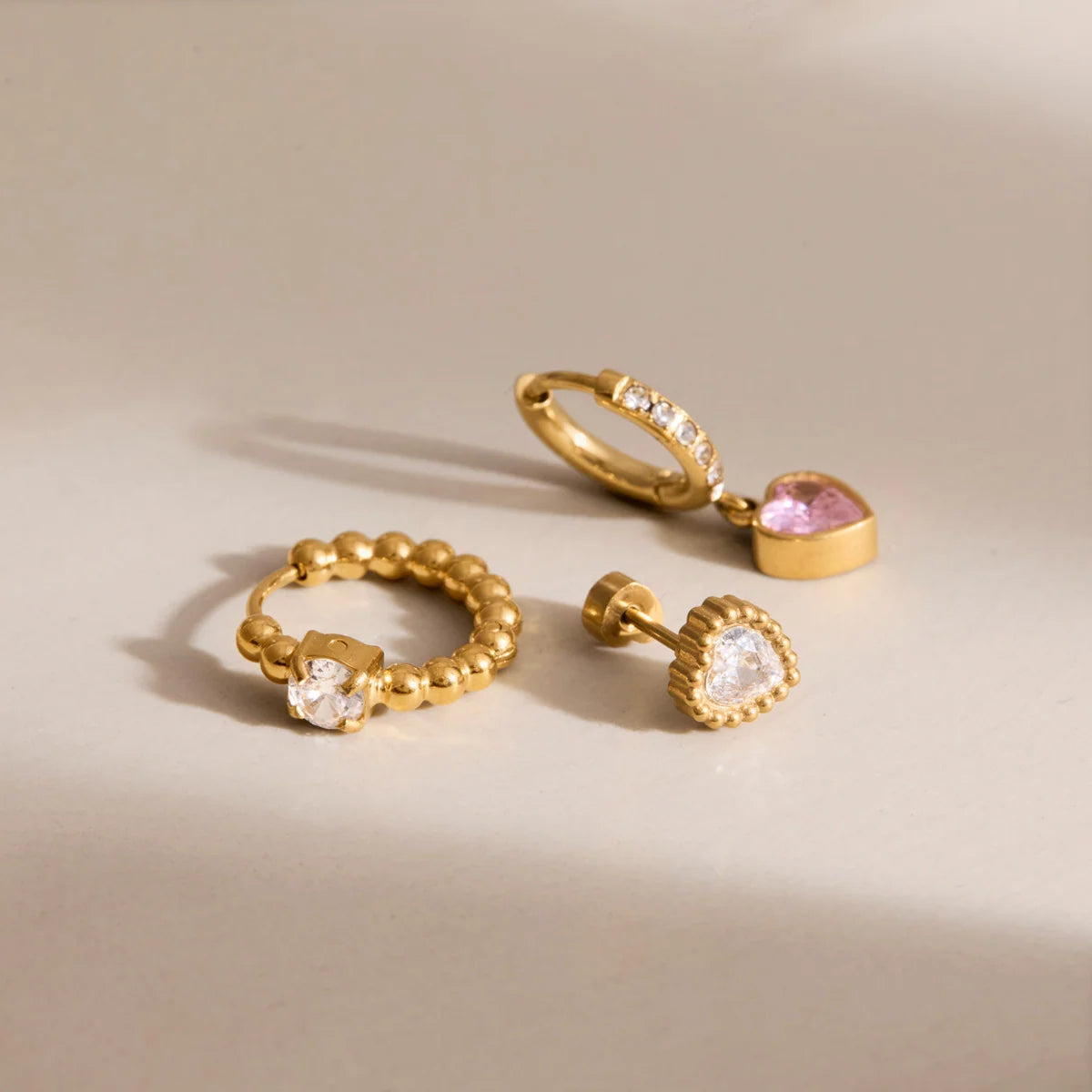 Delilah gold heart earring set with beaded hoop, pink heart drop huggie and heart stud, view 6