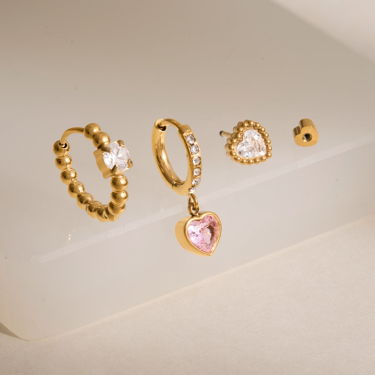 Delilah gold heart earring set with beaded hoop, pink heart drop huggie and heart stud, view 5