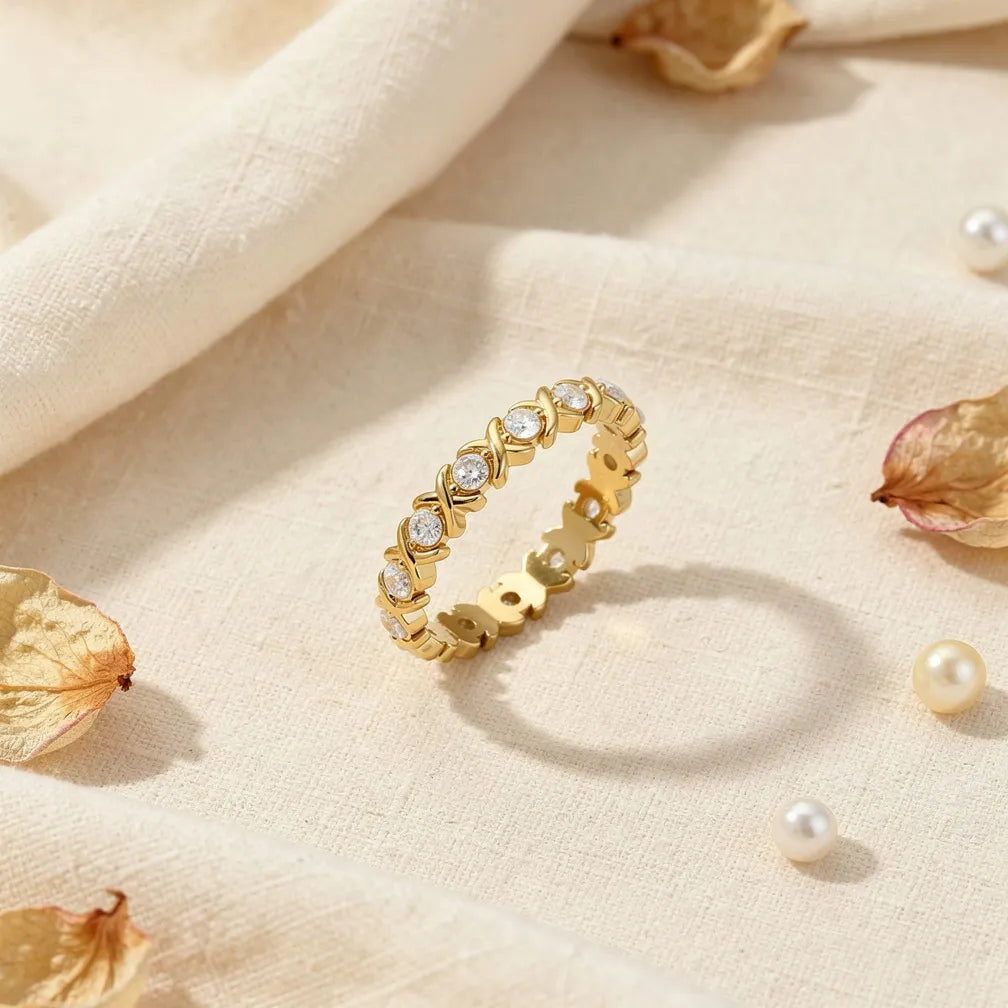 Lacey gold eternity band with alternating X shapes and stones