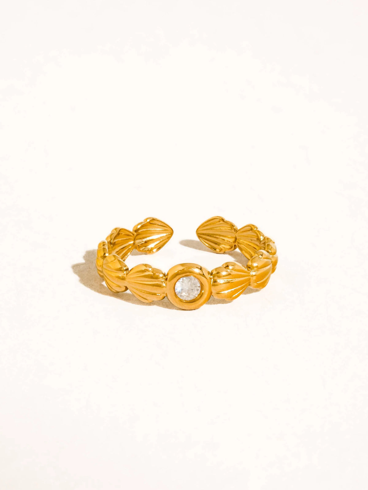 Marina gold scallop shell band ring with a centre stone